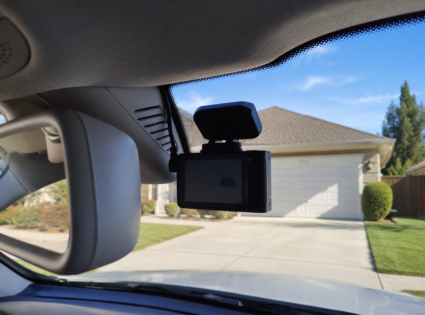 Front dash cam mounted on the windshield with clean, hidden power wiring