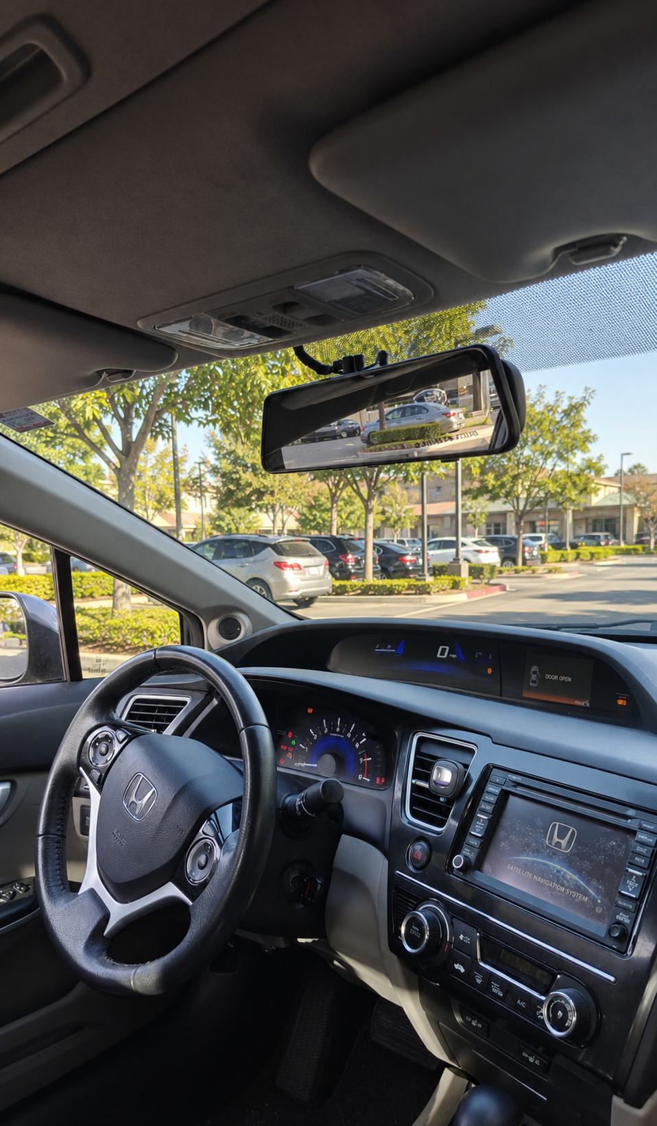 Dash cam mounted near the rearview mirror in a Honda Civic, wiring tucked out of sight